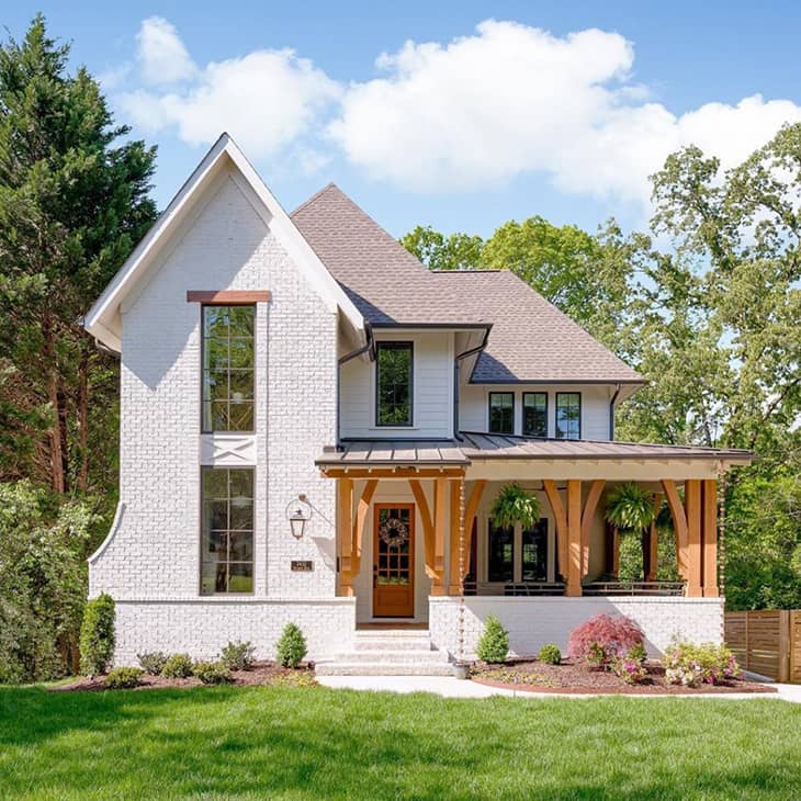 Farmhouse exterior in white brick adn french front door