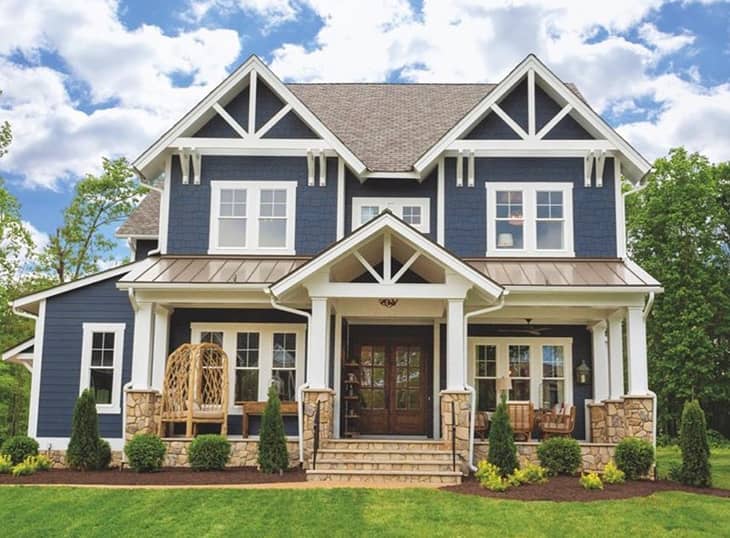 farmhouse exterior with blue walls double french door in wood finish and  white trim on windows