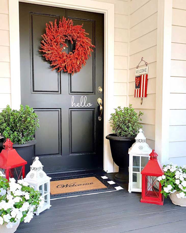 berry wreath on a black front door