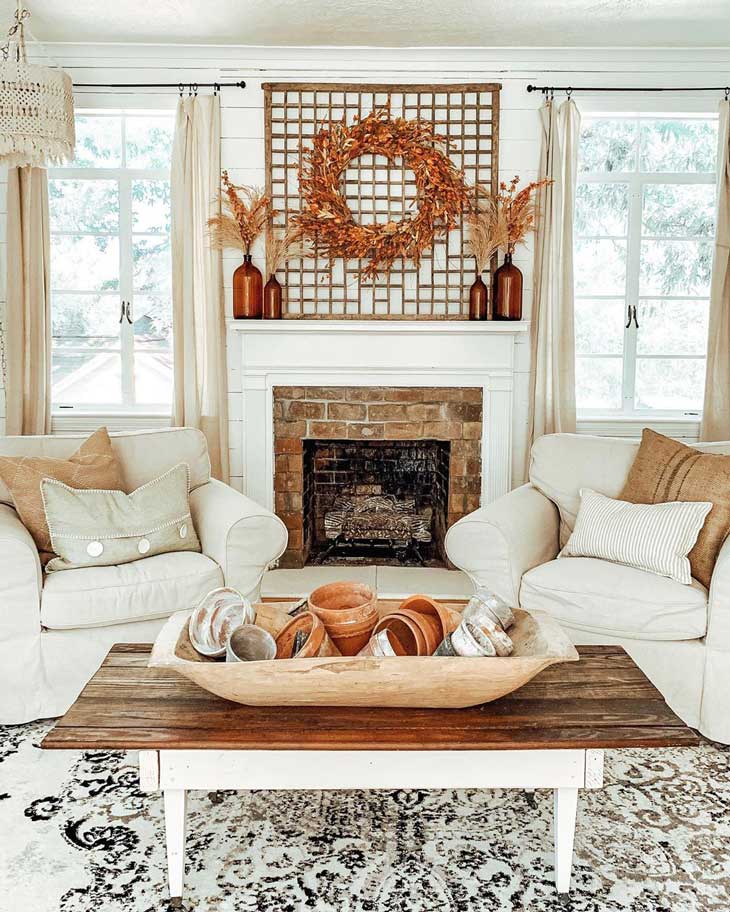 orange fall wreath above brick fireplace in livingroom