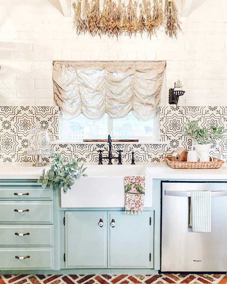 farmhouse sink on teal kitchen with print tiles