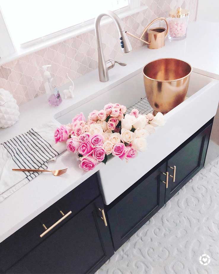 farmhouse sink on black kitchen with pink tiles