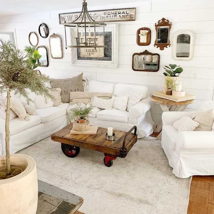 farmhouse gallery wall with mirrors over sectional sofa