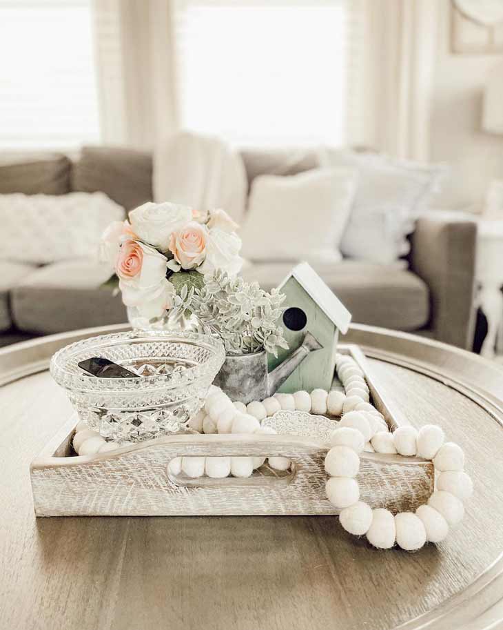 coffee table decor with wood tray, beads and miniature watering can