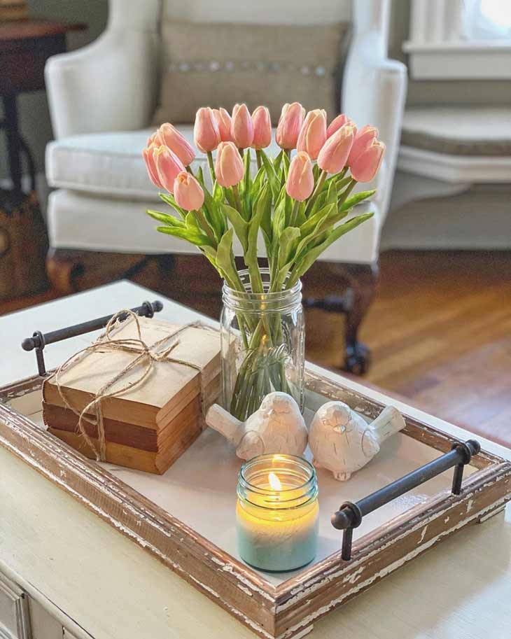 coffee table centerpiece with serving tray with metal handles, fresh tulips and decorative books