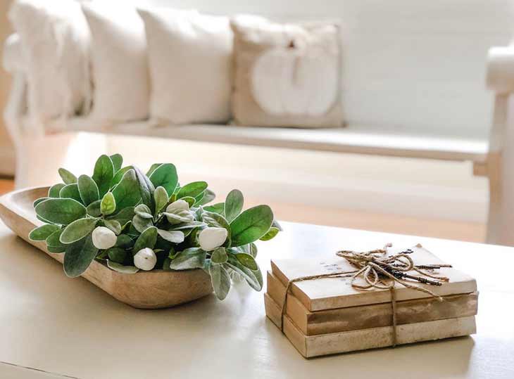 coffee table decor with decorative books and oval serving tray with artificial tulips