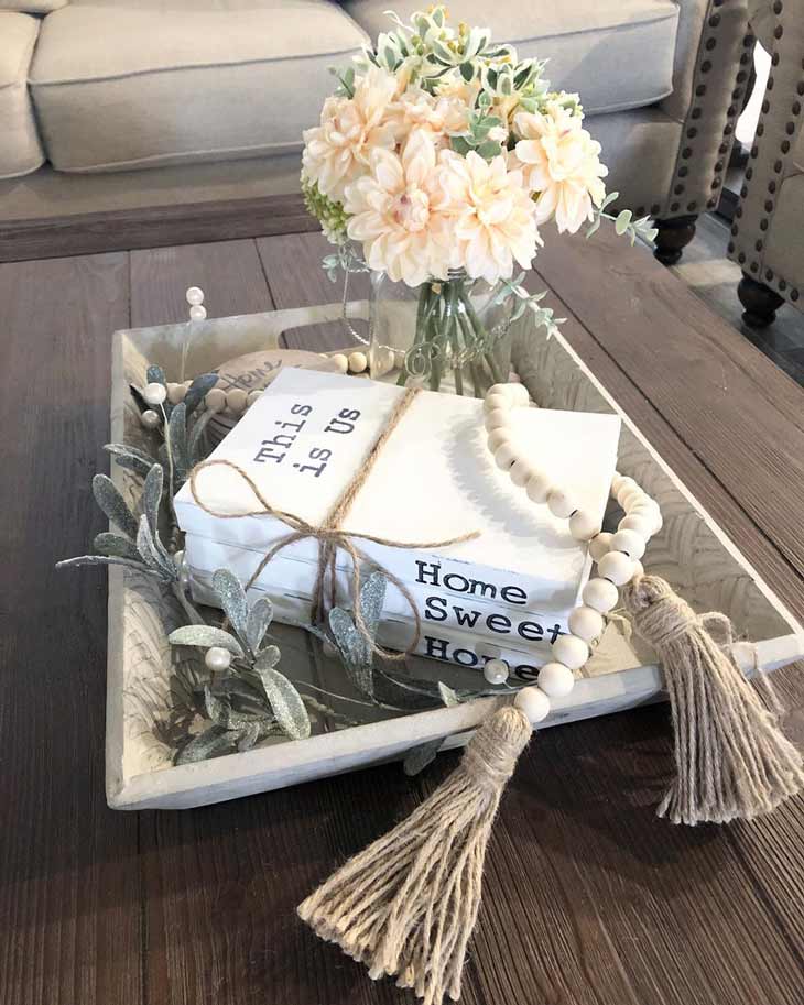 coffee table decor with wood tray, fresh flowers, bead garland and decorative books