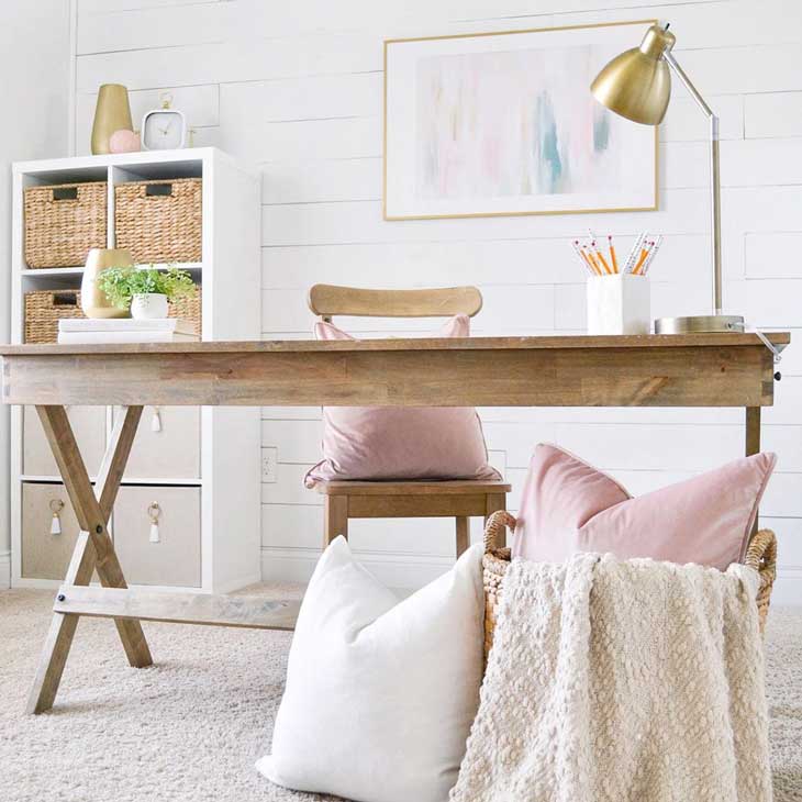 modern home office with pink decor and rustic elegant table