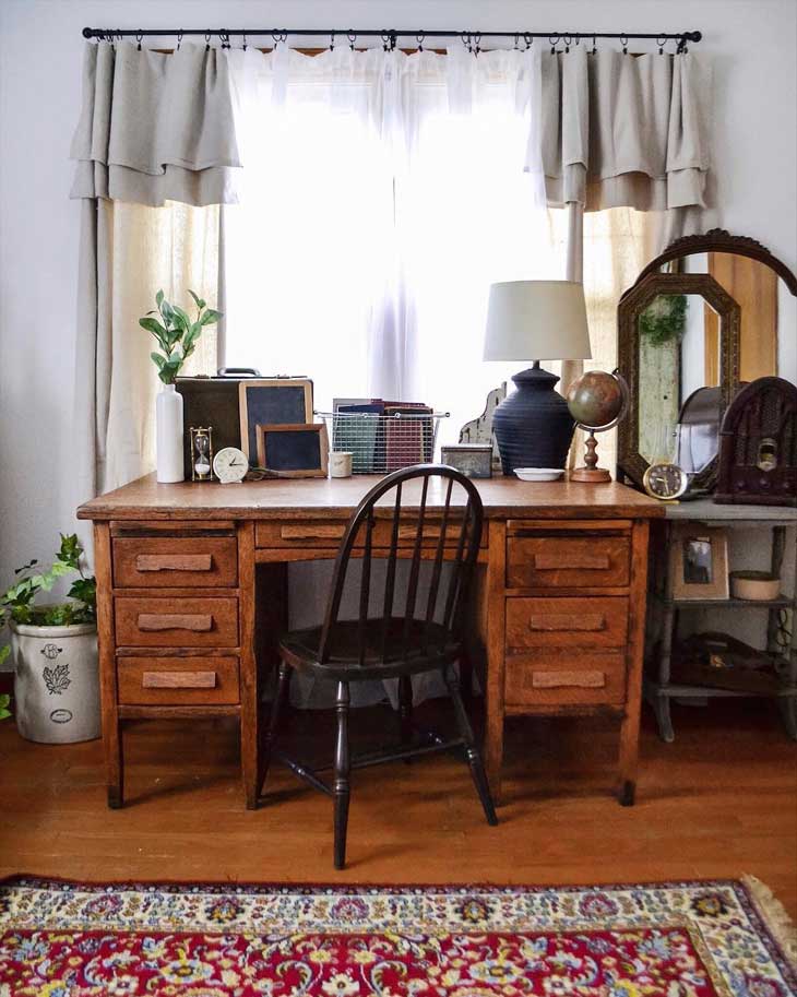 rustic home office with vintage desk in front of window