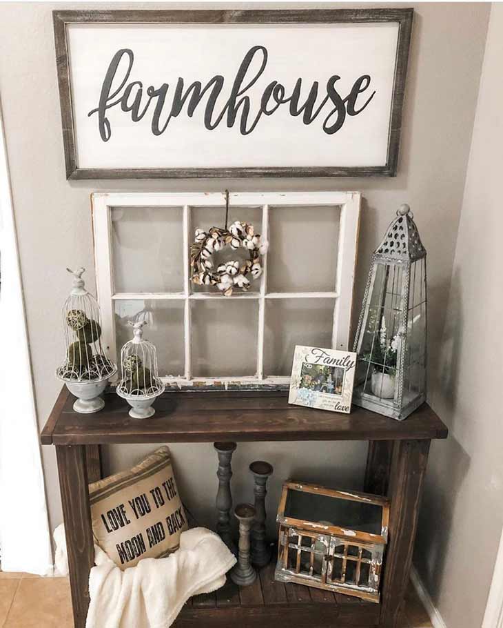 small wooden entryway table with rustic decor and farmhouse sign