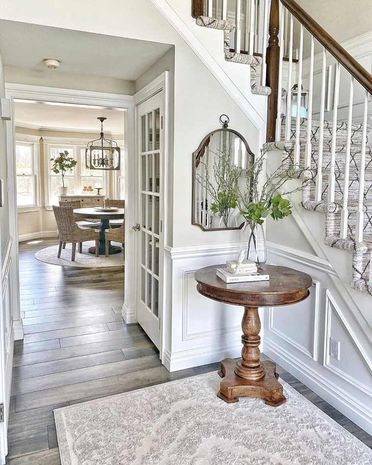 round entryway table with flower arrangement 