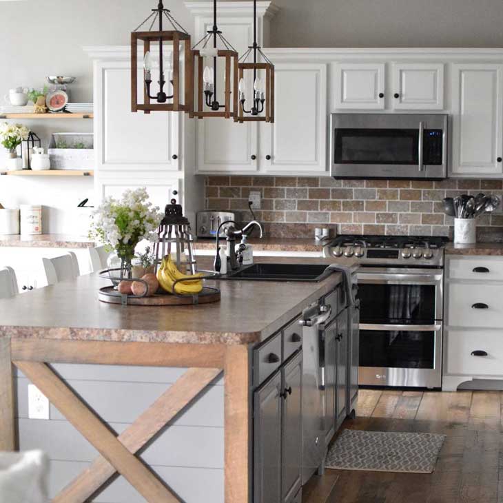 lighting over kitchen island in white kitchen with subway brick backsplash