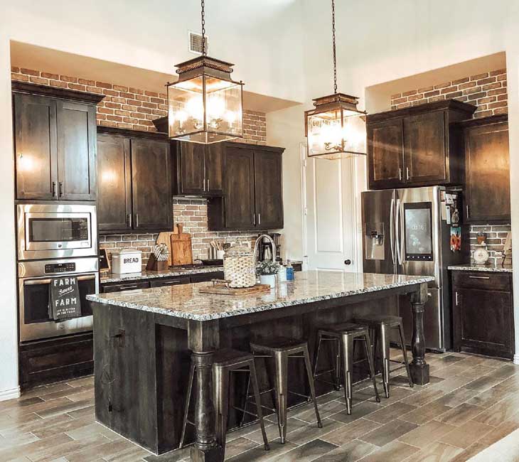 glass box lighting over black kitchen island