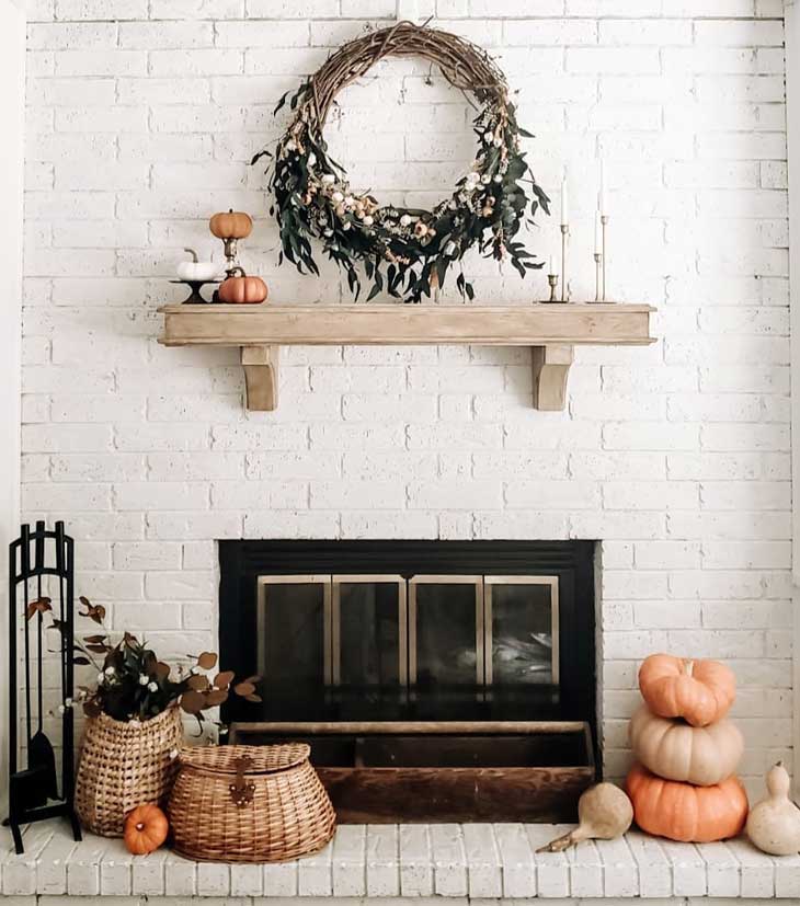 White brick fireplace with fall mantel decor