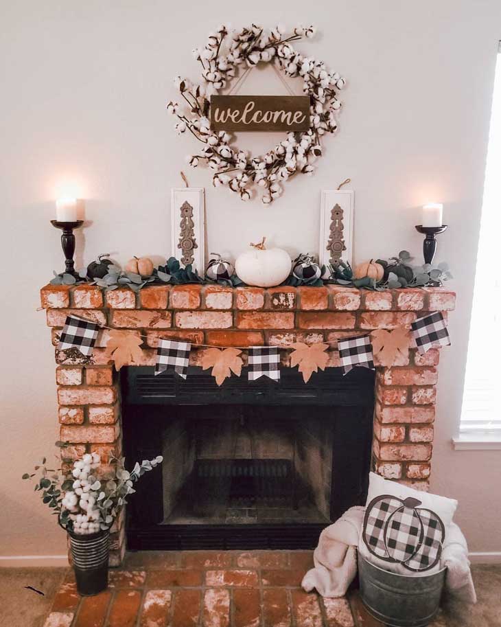 Fall fireplace decor with buffalo check and white pumkins