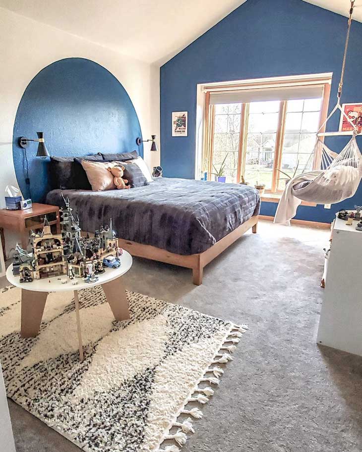 Blue kids room with blue accent wall and large windows