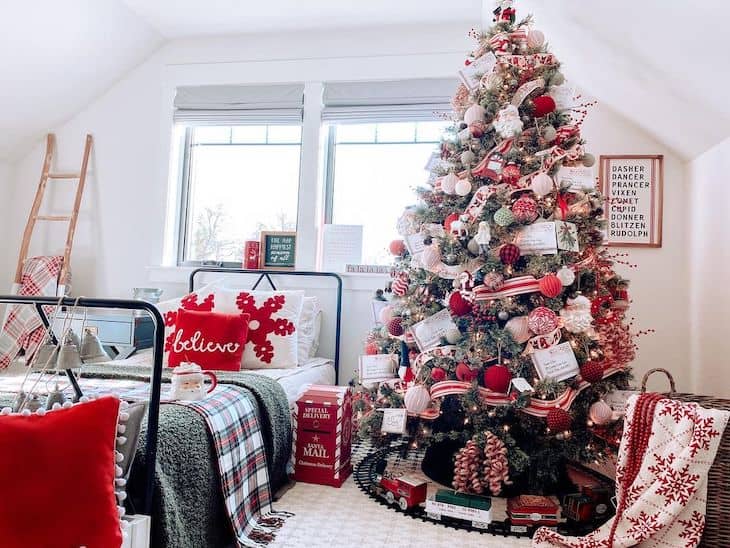 Red and white Christmas tree for kids  attic room with black metal bed