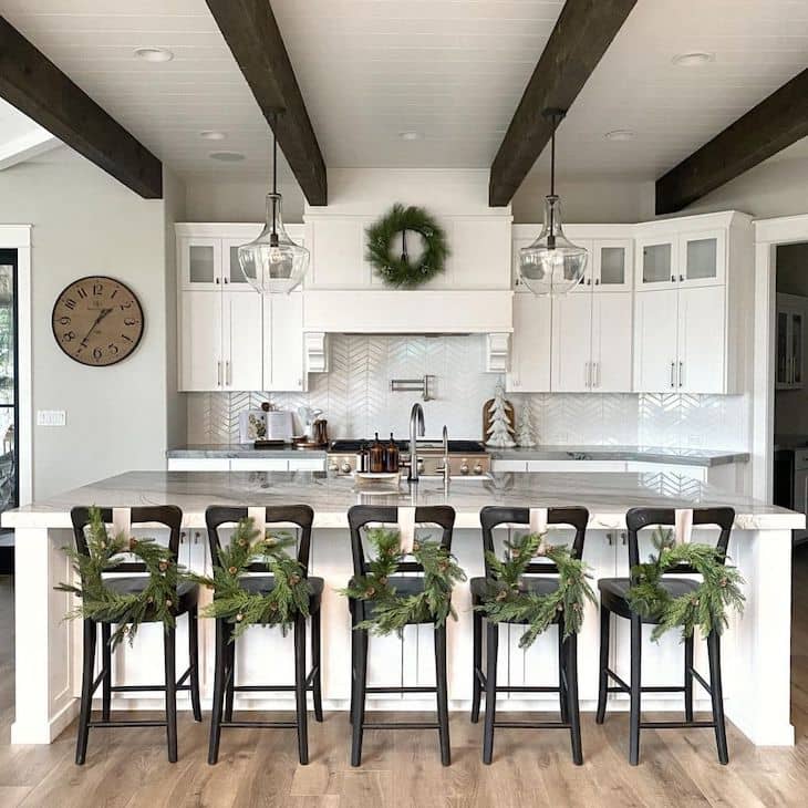 White kitchen with black counter stools with Christmas decor