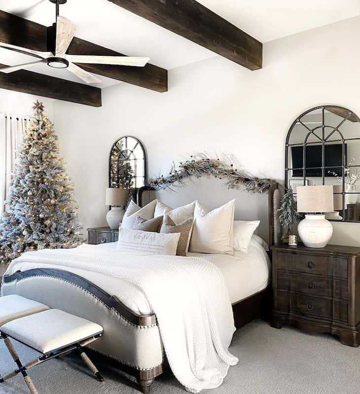 Christmas decor in master bedroom with brown furniture and wood beams