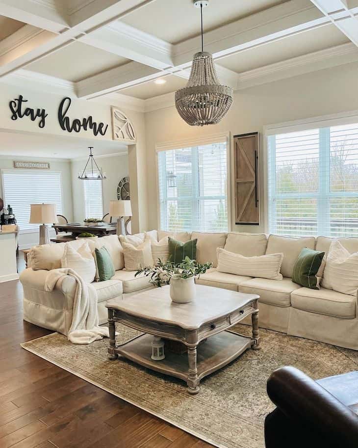 Neutral farmhouse living room with grid beam ceiling and square farmhouse coffee table