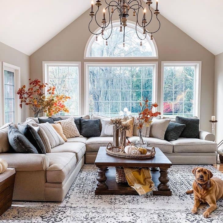 Traditional living room painted in Revere Pewter with neutral sectional and dark wood square coffee table