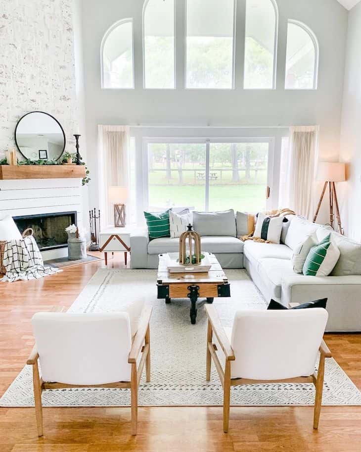 Living room with corner fireplace in shiplap and big windows