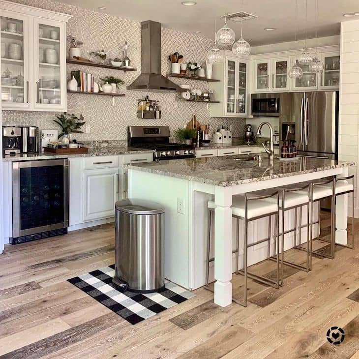 Open shelf kitchen with metal shelves, glass cabinets and silver appliances 