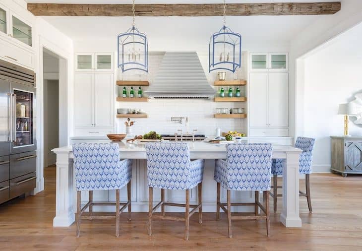 Coastal kitchen with open shelves around the range hood