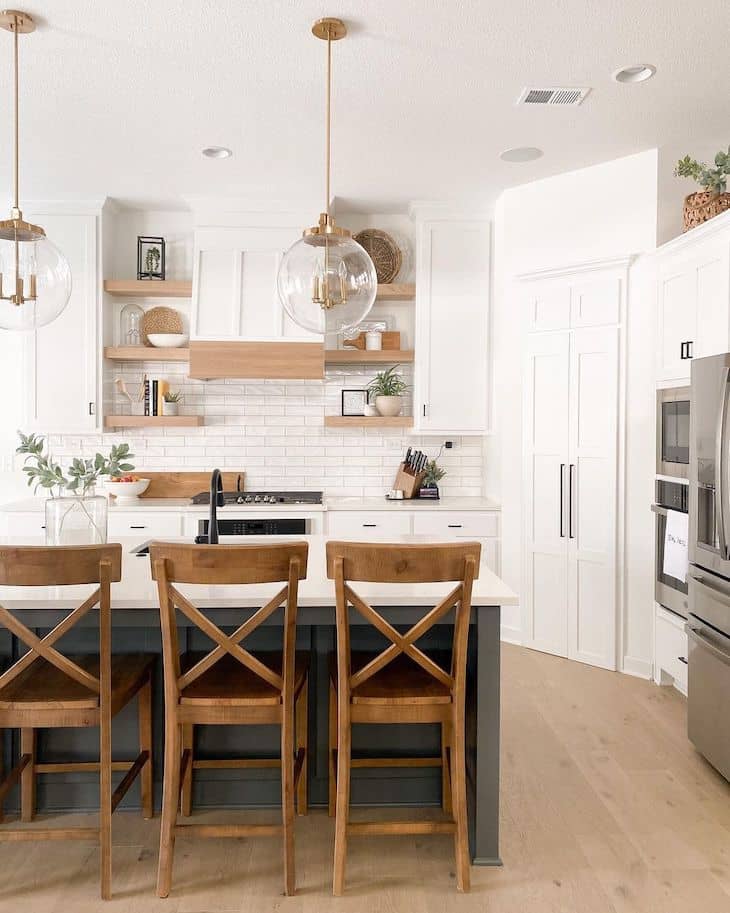 Modern farmhouse kitchen with different island and oak shelves