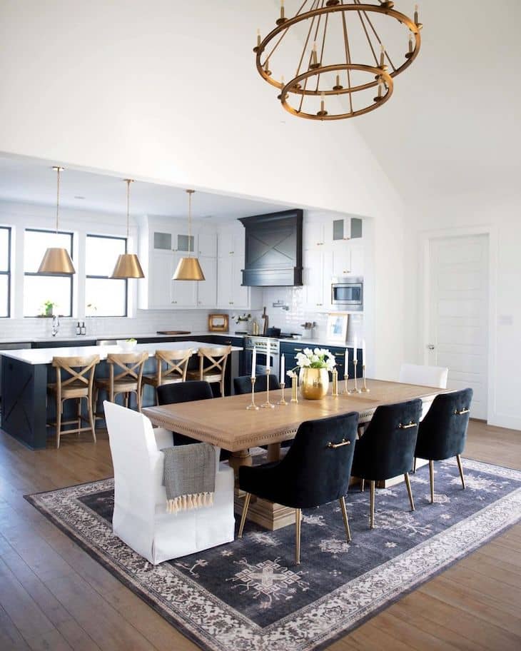 Dining room with 8 seater wood dining table, velvet chairs and rug