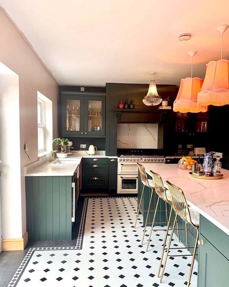 Deep forest green kitchen with marble backsplash and marble counter