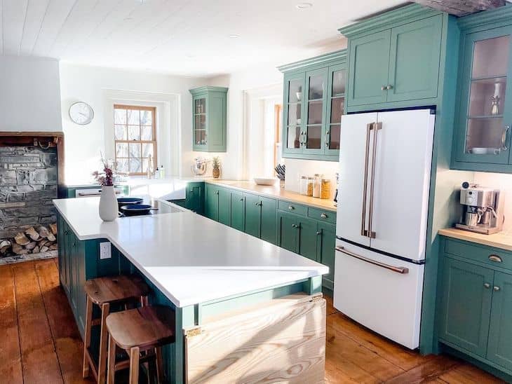 Modern farmhouse green kitchen with rustic stools