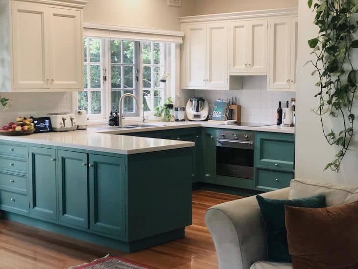 Kitchen with green lower cabinets and white upper cabinets