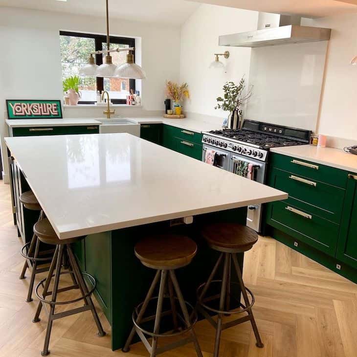 Bold shade of green kitchen, with no upper cabinets. 