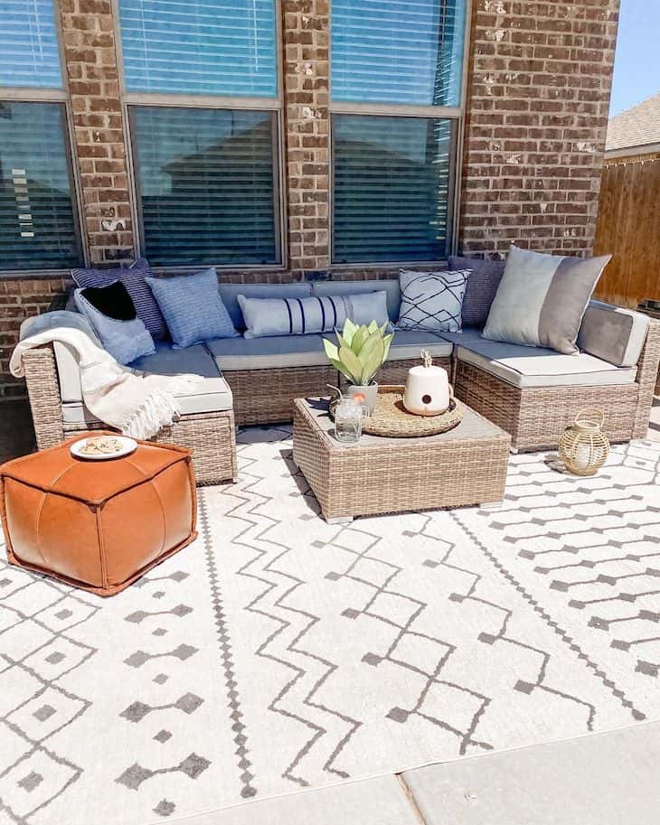 Patio decor with wicker furniture and boho pouf