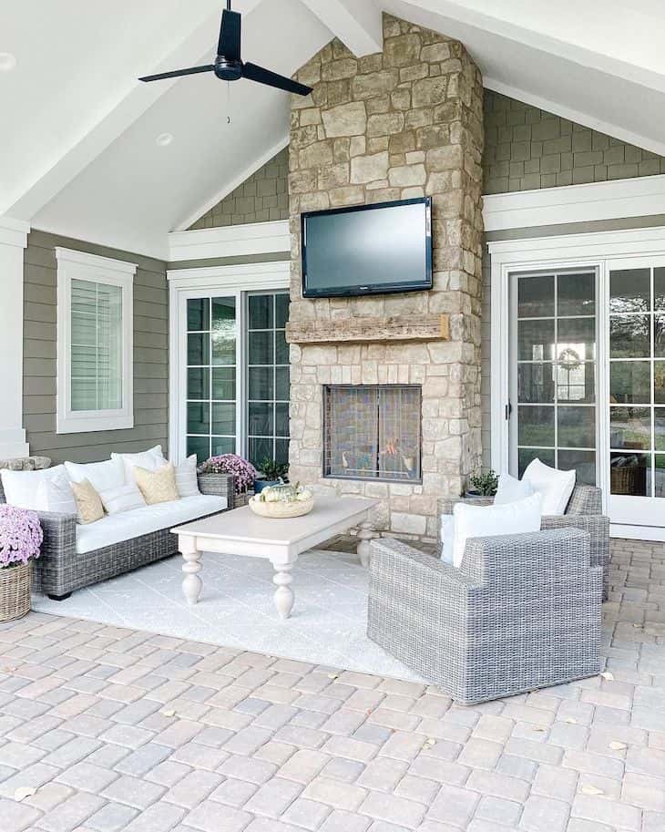 Outdoor living room with fireplace and wicker furniture