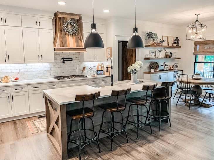 White farmhouse kitchen with wood island and black accents