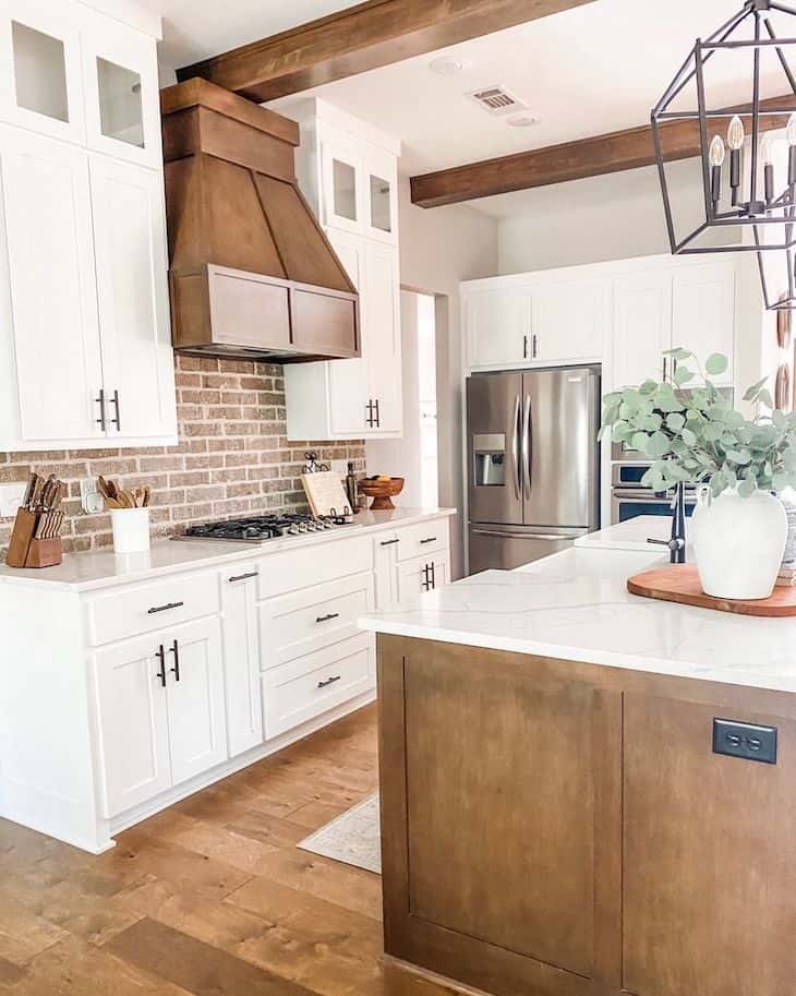 White and wood kitchen with red brick backsplash