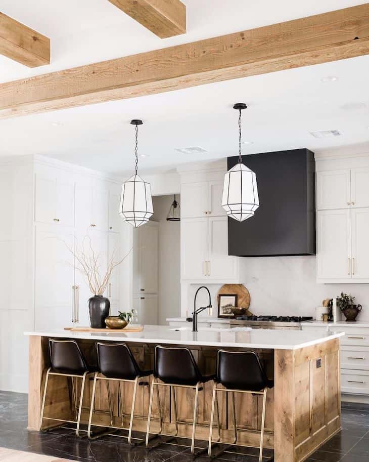 Modern farmhouse kitchen with white cabinets and reclaimed wood kitchen island