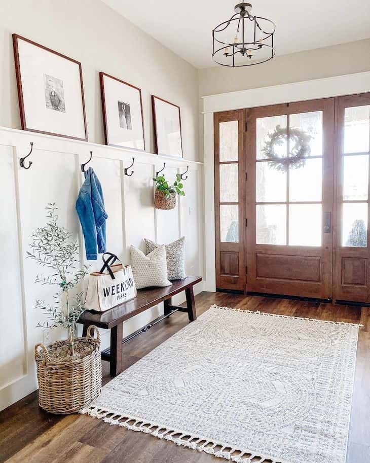 Entry way decor with a wooden bench and half board and batten wall