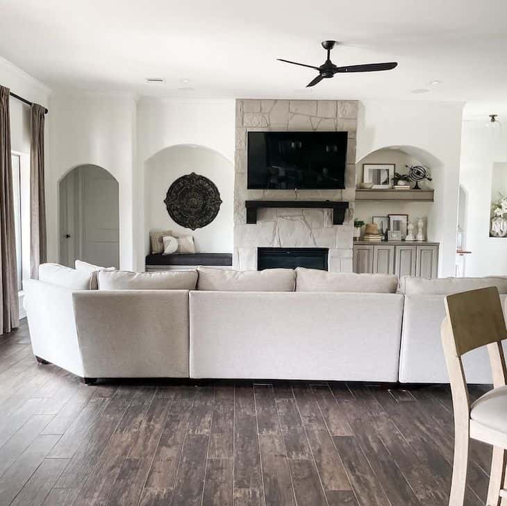 Alabaster white walls and grey stone fireplace