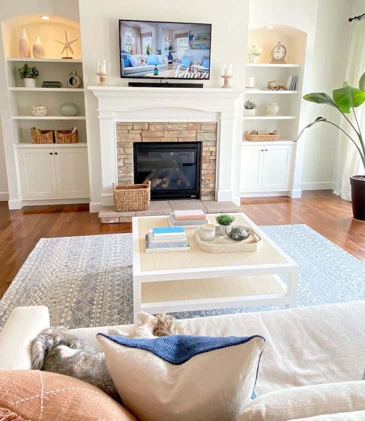 Living room walls and built-ins painted in Alabaster white against dark wood floors