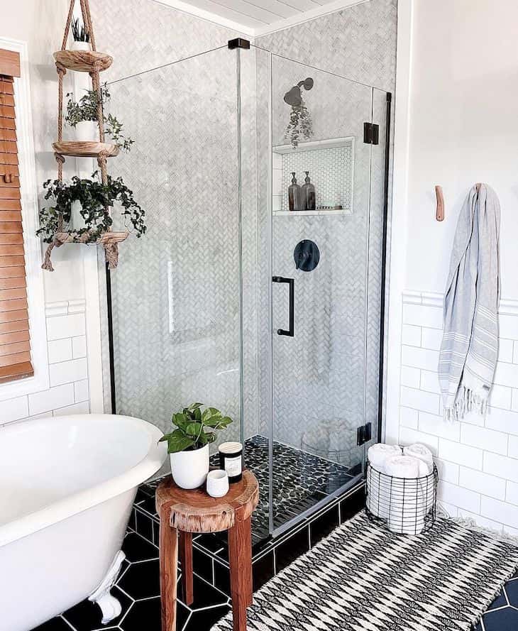 Small herringbone shower tile with black shower floor tile