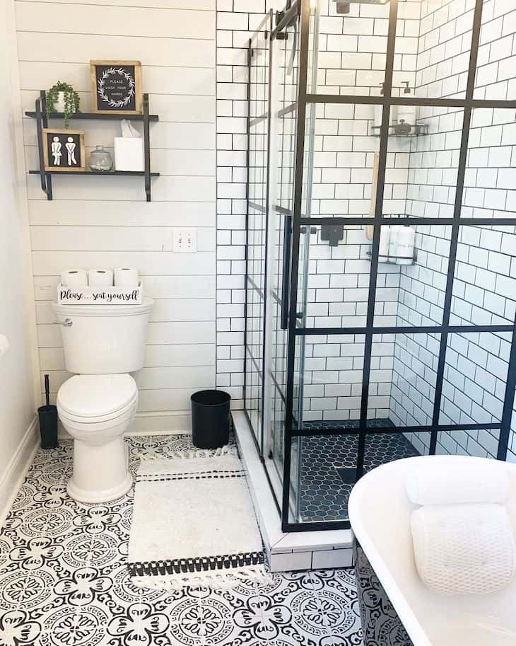 Shower subway tile with black grout and honeycomb shower floor tile