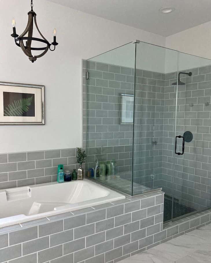 Grey shower tile in subway pattern with in-shower bench