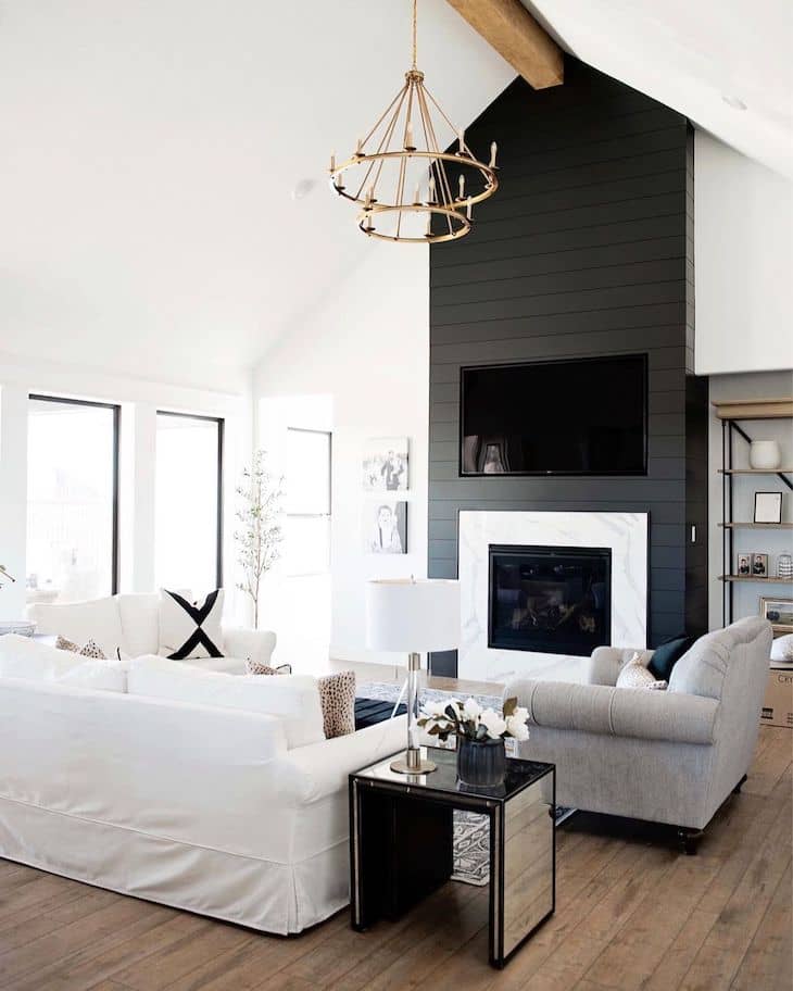 Black shiplap fireplace with a contrasting white marble