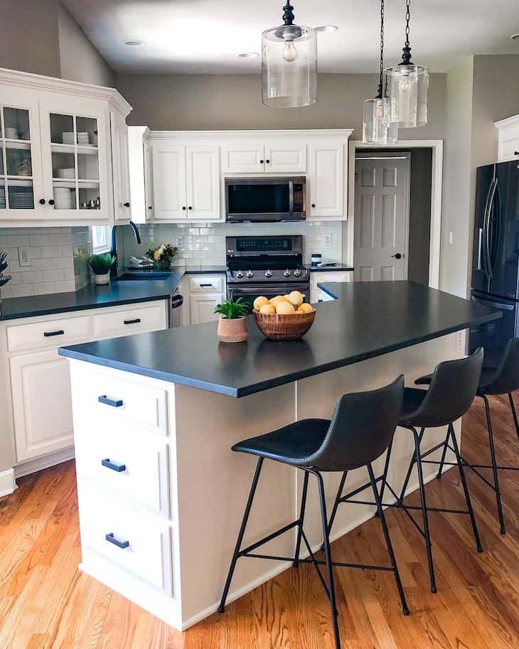 Black quartz countertop in a striking white kitchen