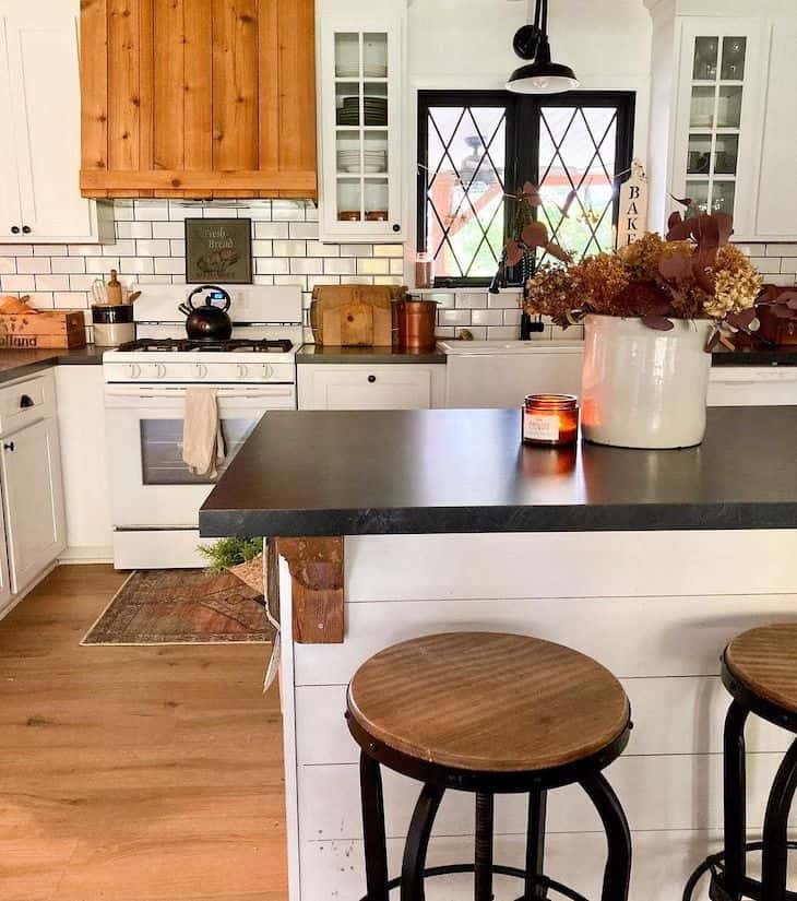 White farmhouse kitchen with black marble countertops