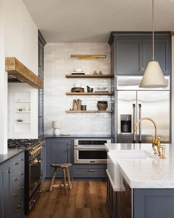 Dark blue kitchen cabinets with black countertop