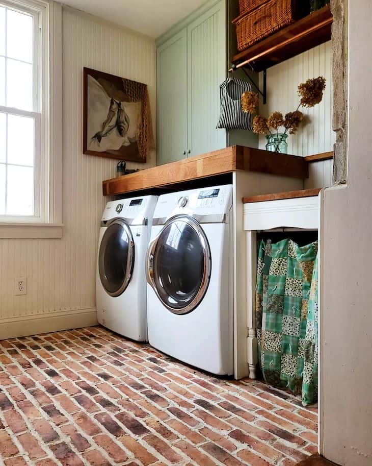 Small laundry room with brick floor